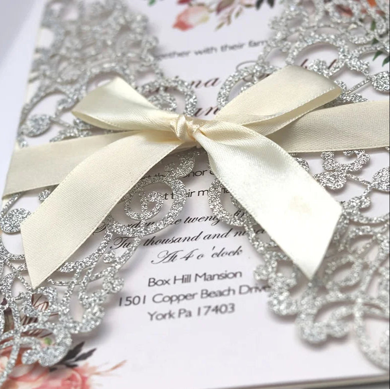 Decorative wedding invitation with a bow and floral design