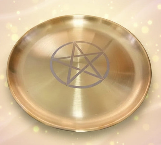 Gold plate with a pentagram symbol on a black background