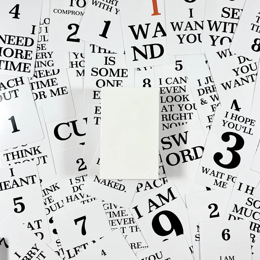 Scattered cards with various phrases on a white background