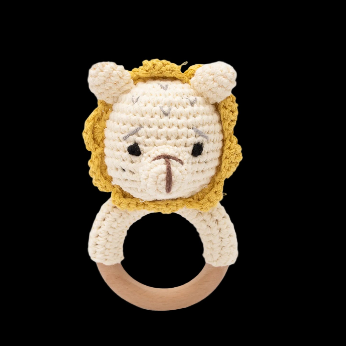 Crocheted lion rattle toy with wooden ring on a white background