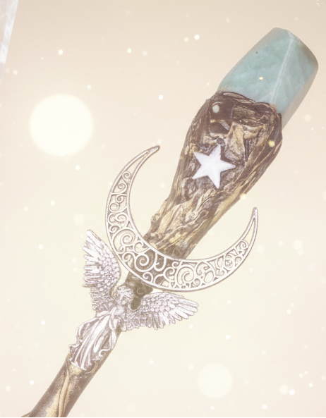 Decorative wand with celestial design on a blue textured background