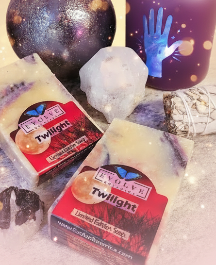 Two soap bars with 'Twilight' packaging on a textured surface with decorative items.