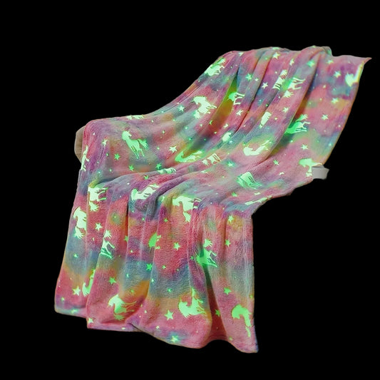 Colorful blanket with animal patterns draped over a couch in a living room.