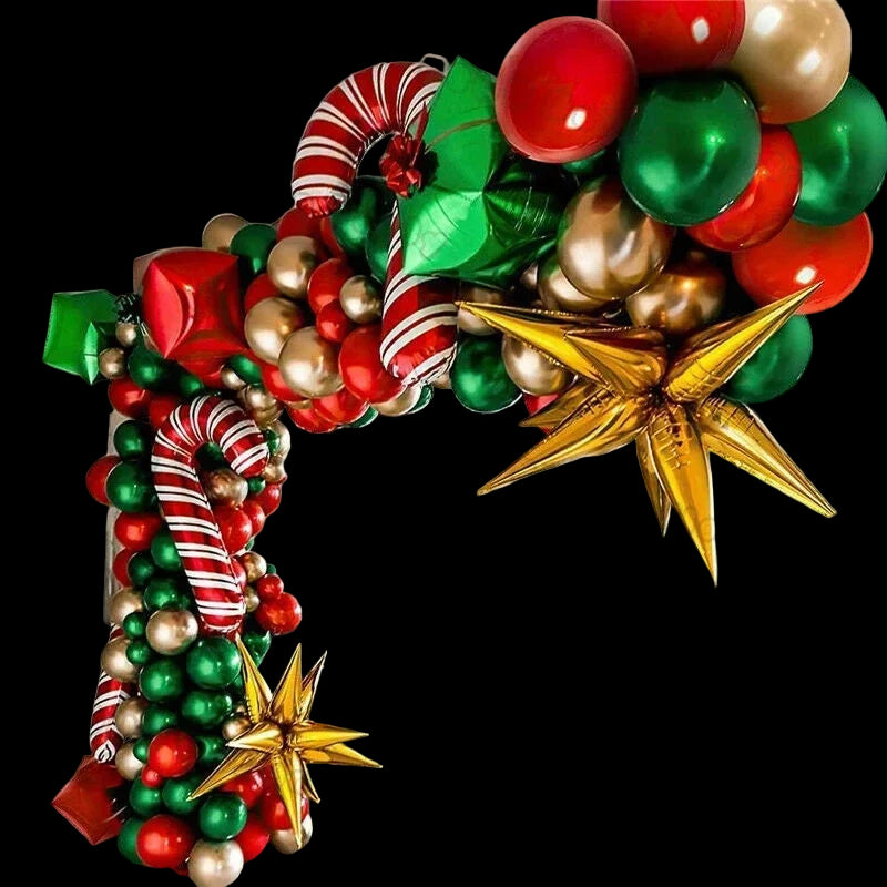 Colorful Christmas-themed balloon arch in a room with a Christmas tree.