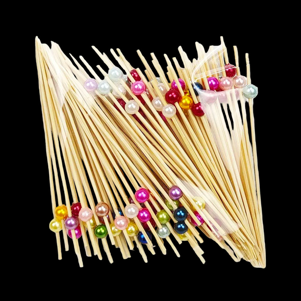 Packaged wooden skewers with colorful beads on a white background