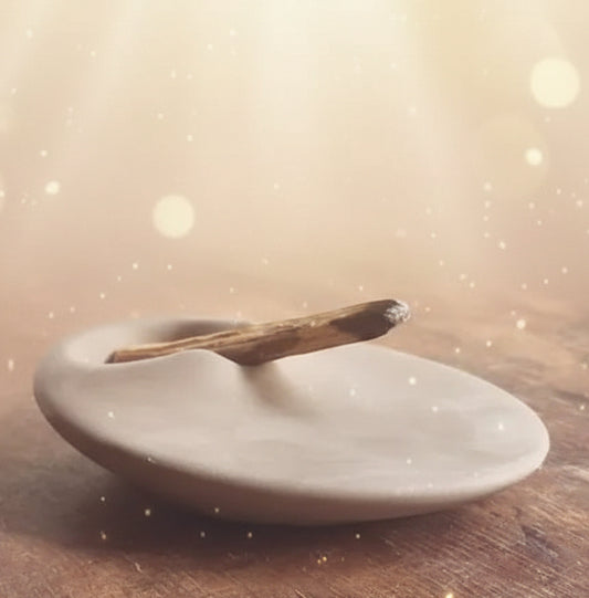 Ceramic dish with a wooden spoon on a wooden surface