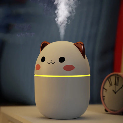 Cute cat-shaped humidifier emitting steam with a blurred background