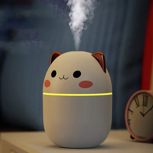 Cute cat-shaped humidifier emitting steam with a blurred background