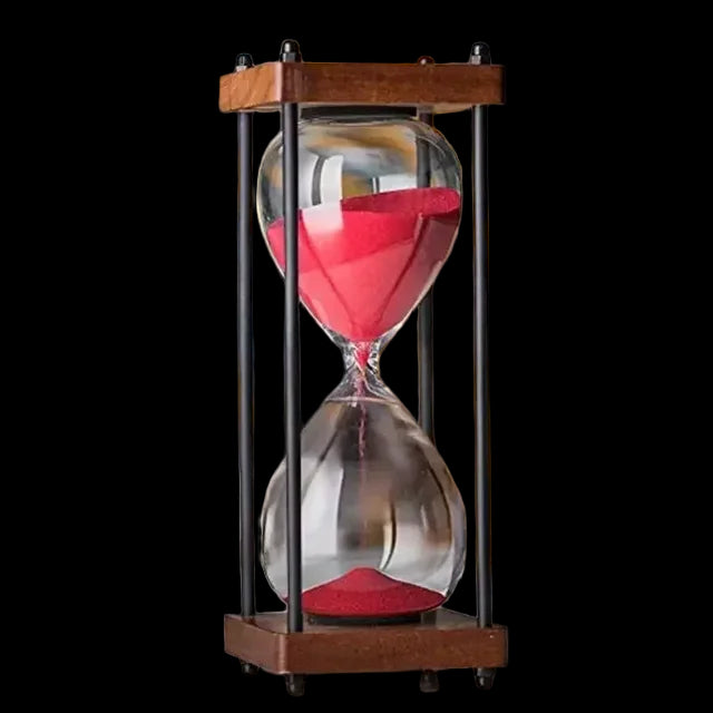 Small sand timer with red sand on a blurred background
