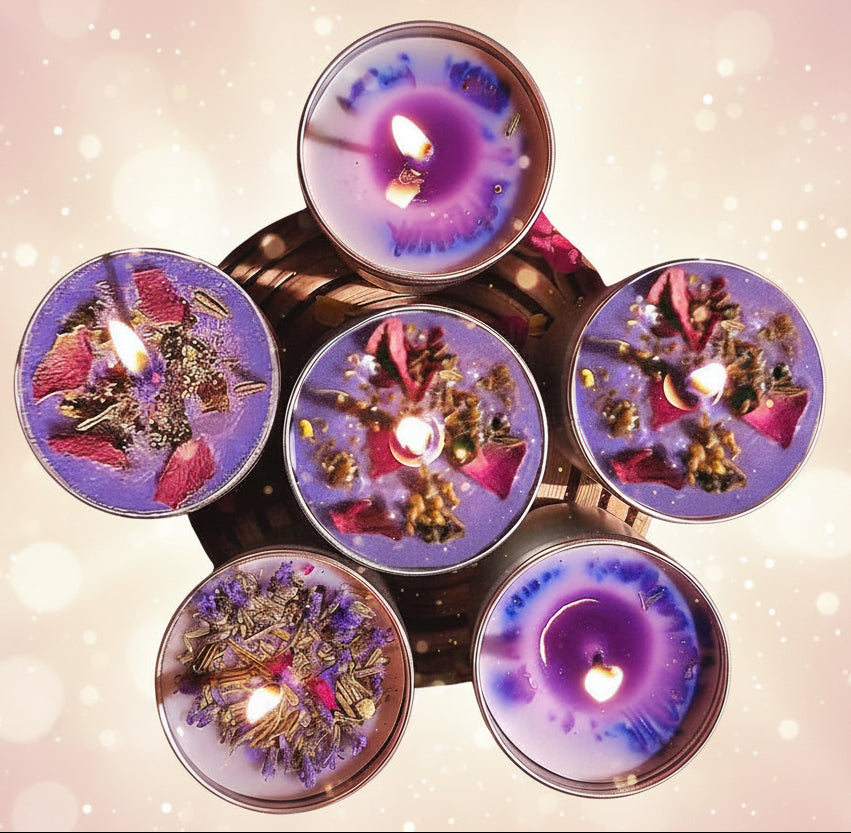 Decorative candles with floral elements on a green surface