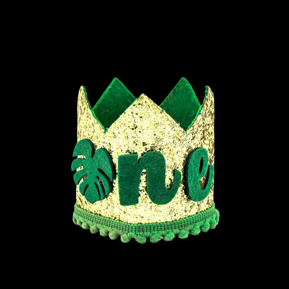 Gold glitter crown with green leaves and 'one' text on a white background