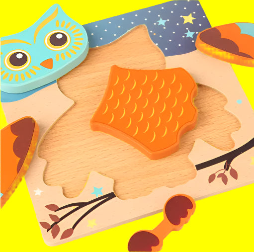 Wooden owl puzzle with colorful pieces on a white background