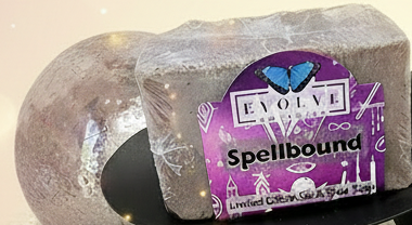Spellsor soap with a bottle and decorative items on a textured surface with a brick wall background