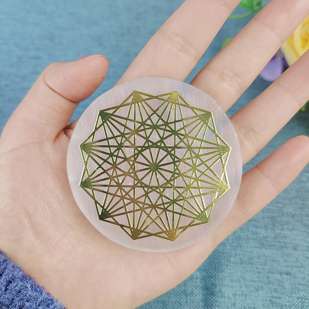 Hand holding a geometric design coaster with a blue background