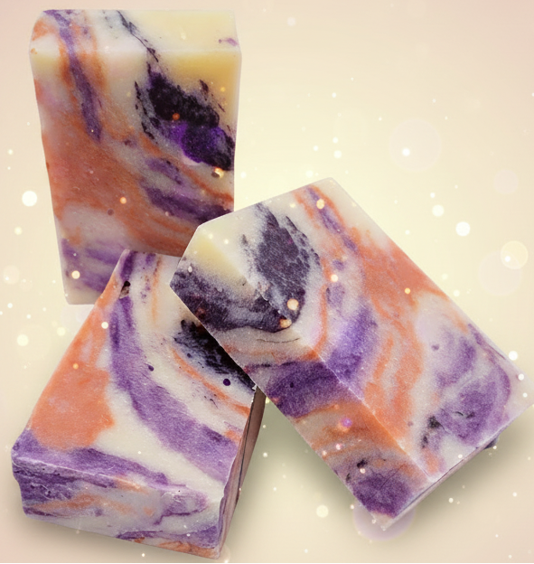 Three bars of colorful soap with swirl patterns on a black background