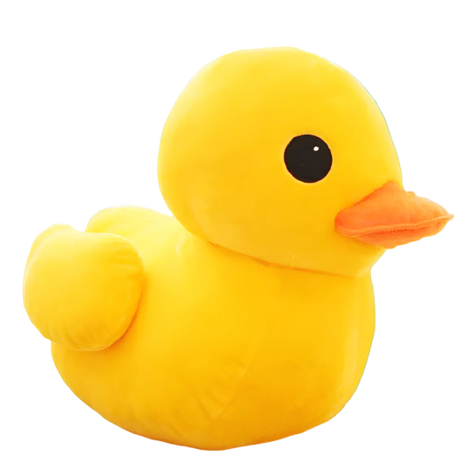 Yellow plush duck toy on a wooden surface with a light-colored background