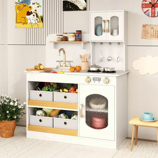 Children's play kitchen set with various accessories in a room setting.
