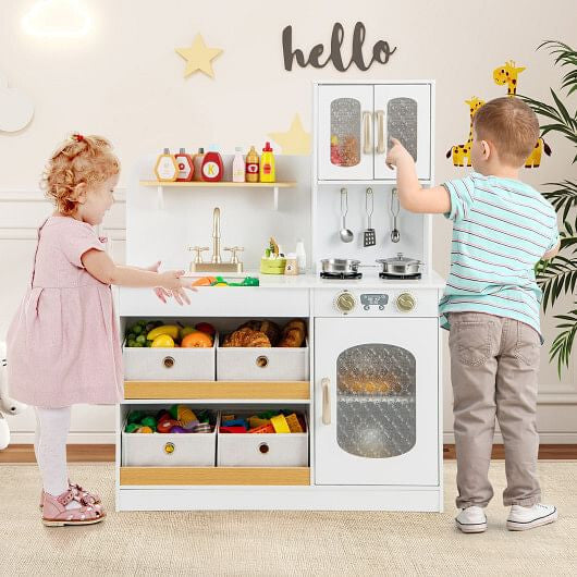 Children playing with a toy kitchen set in a room with decorative elements.