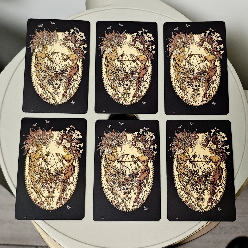 Set of six tarot cards with intricate designs on a white surface