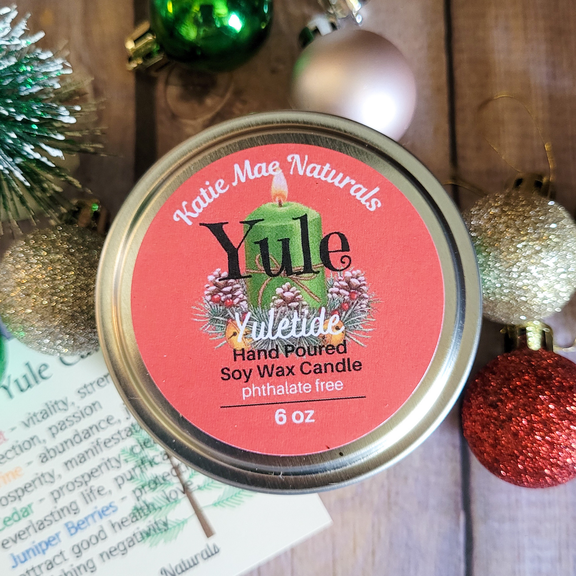Katie Mae Naturals Yule candle with Christmas ornaments in the background