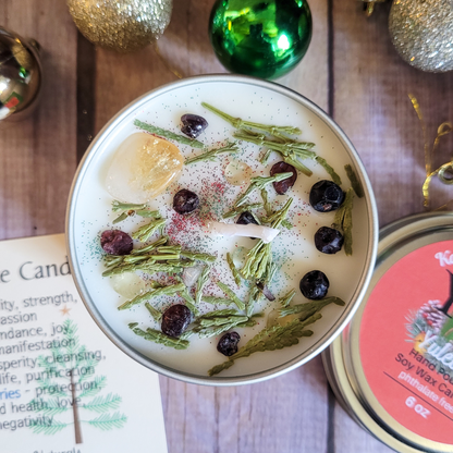 Decorative candle in a tin with herbs and berries on a wooden surface