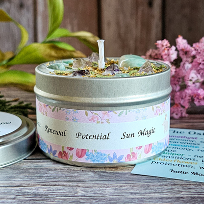 Candle in a tin with decorative label on a wooden surface