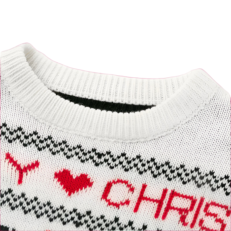 Close-up of a white sweater with red and black pattern and text