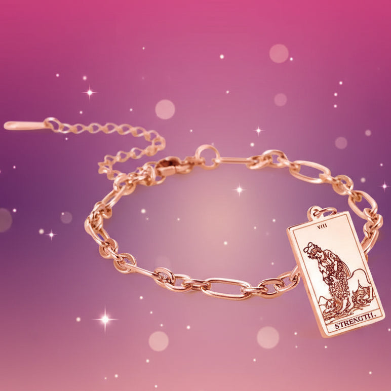 Gold bracelet with a tarot card charm on a white background