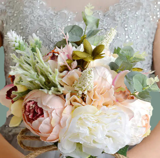 Bouquet of flowers held by a person wearing a silver dress.
