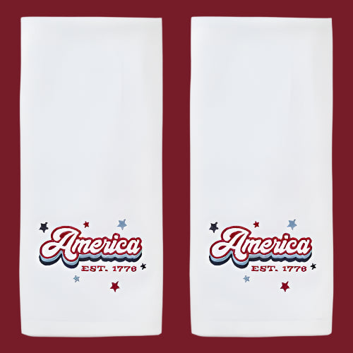 Two white towels with 'America EST. 1776' text design on a white background