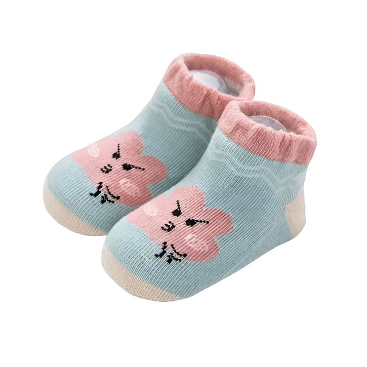 Pair of baby socks with pink flowers and green background