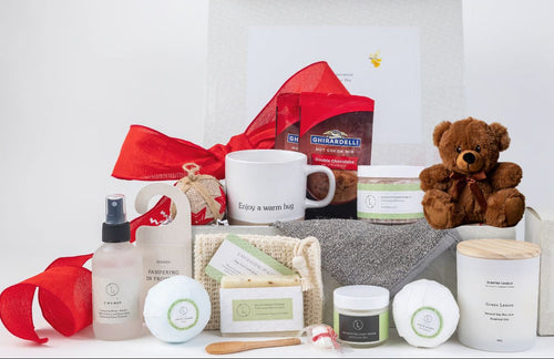 Gift set with a mug, teddy bear, and various items on a white background
