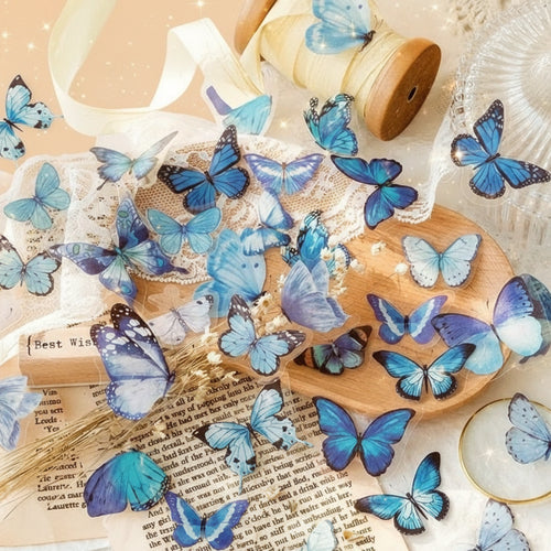 Blue butterflies on a wooden surface with a shell and text in the background