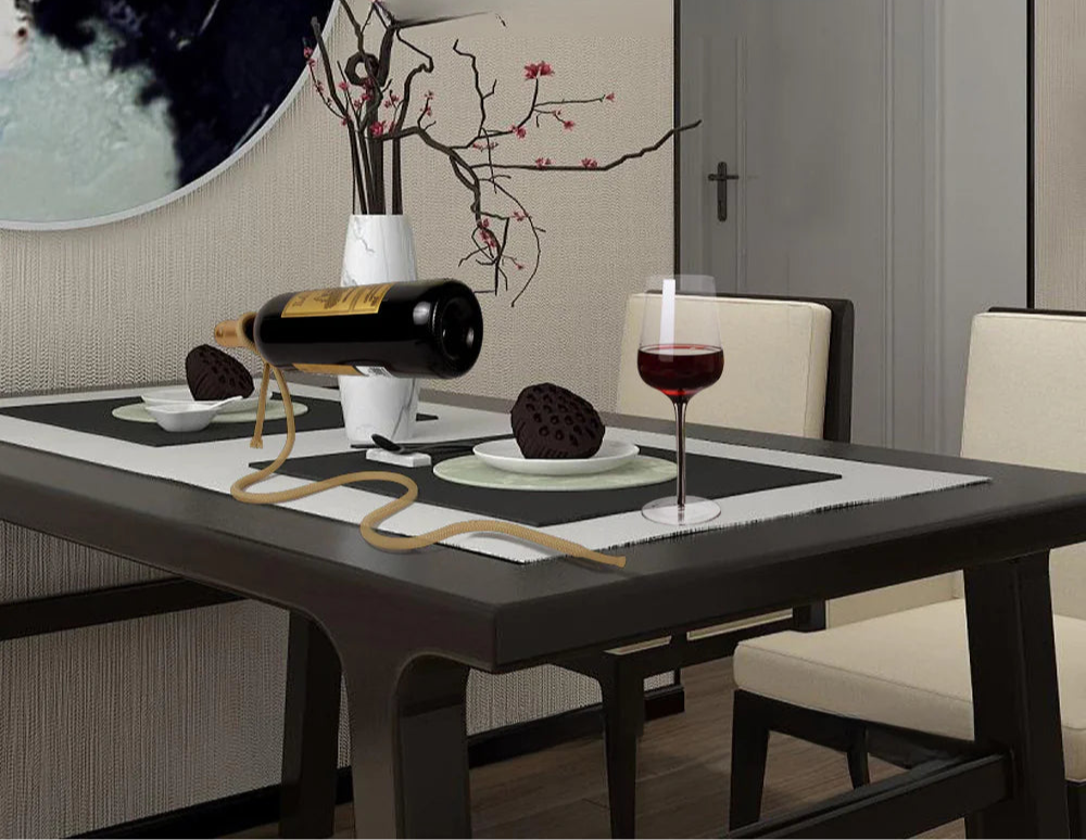 Dining table setting with wine and cookies, modern home decorations in the background