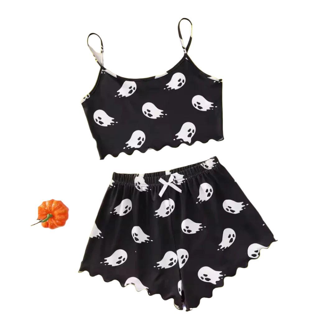 Black and white ghost-patterned top and shorts set on a light background with decorative items.