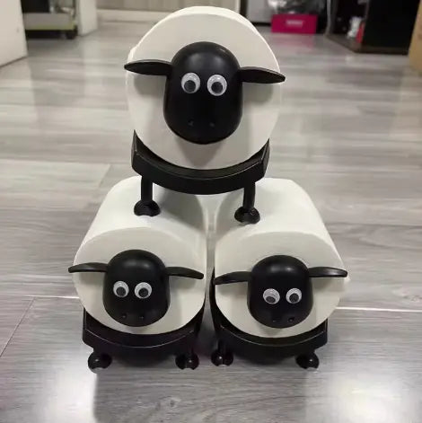 Stack of white containers with black sheep faces on a wooden floor