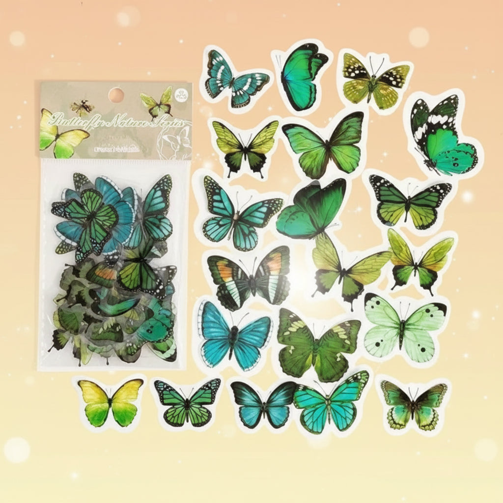 Collection of green and blue butterfly decorations with packaging on a white background