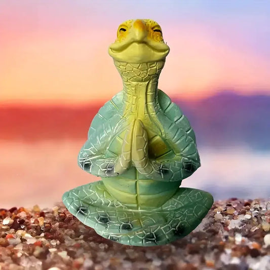 Green and yellow lizard-like figurine on a beach with a colorful sky background