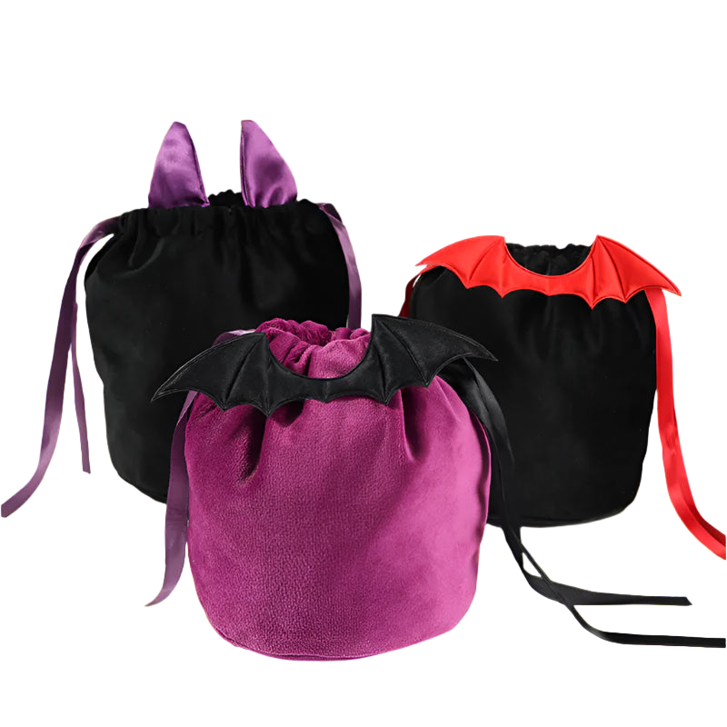 Three Halloween-themed drawstring bags with bat wings on a white surface.