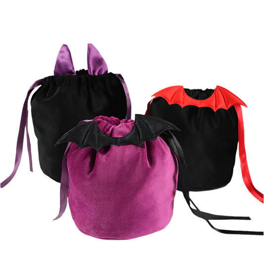 Three Halloween-themed drawstring bags with bat wings on a white surface.