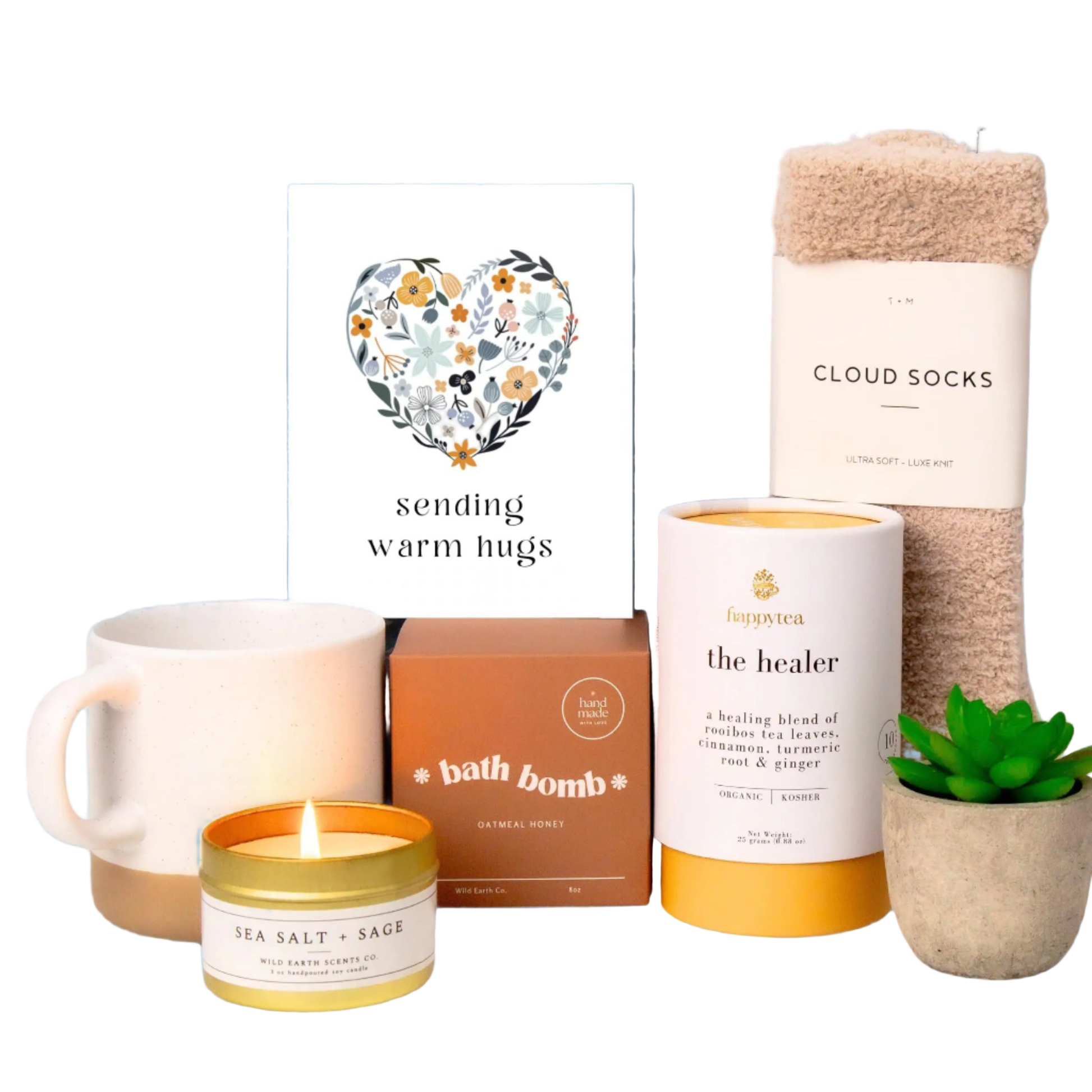 Collection of self-care items including a mug, candles, and bath products with a 'sending warm hugs' card.
