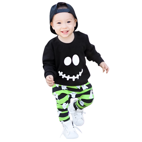 Child wearing a black shirt with a smiley face and green striped pants on a white background
