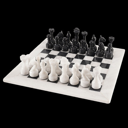 Black and white chess pieces on a checkered board
