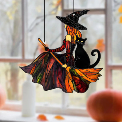 Decorative stained glass Halloween decoration with witch and black cat on a broom.
