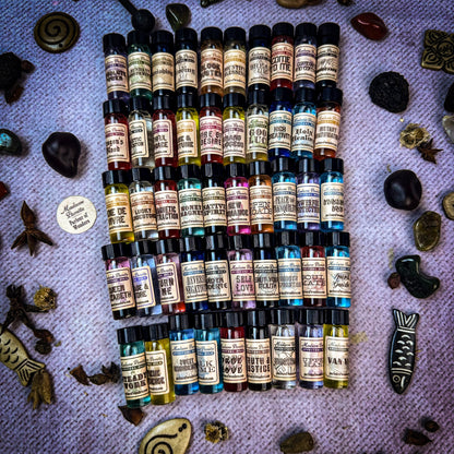 Collection of small bottles with labels on a textured surface with natural elements.