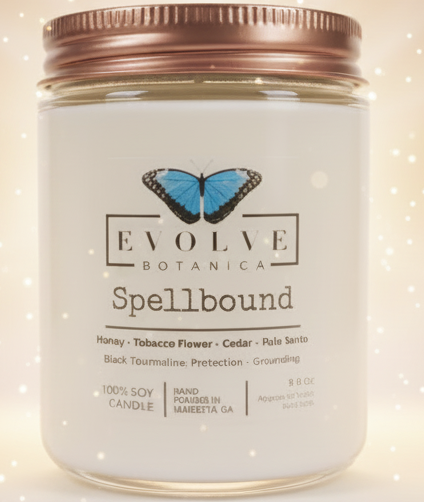 Evolve Botanica Spellbound candle on a marble surface with a blurred background