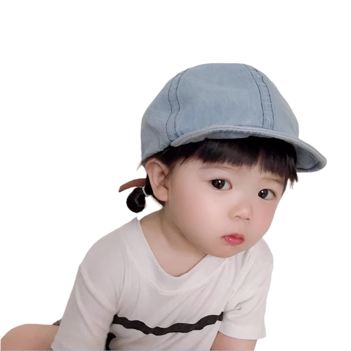 Child wearing a denim cap against a plain background