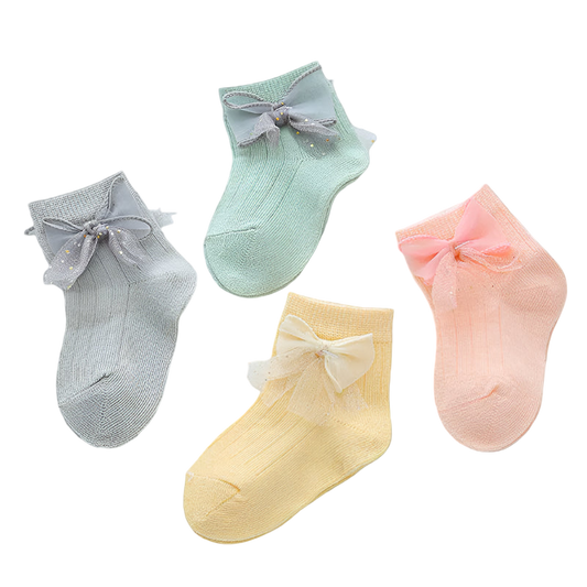 Four pairs of colorful socks with bows on a light background