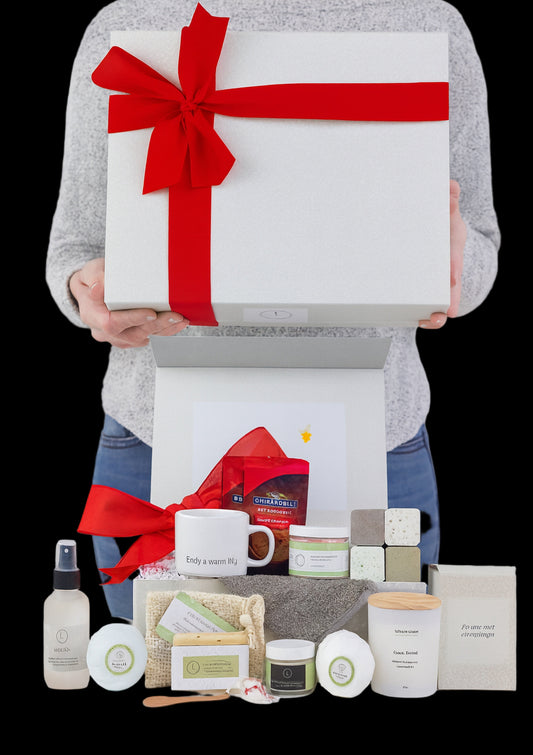 Person holding a large gift box with a red ribbon, surrounded by various items on a white background