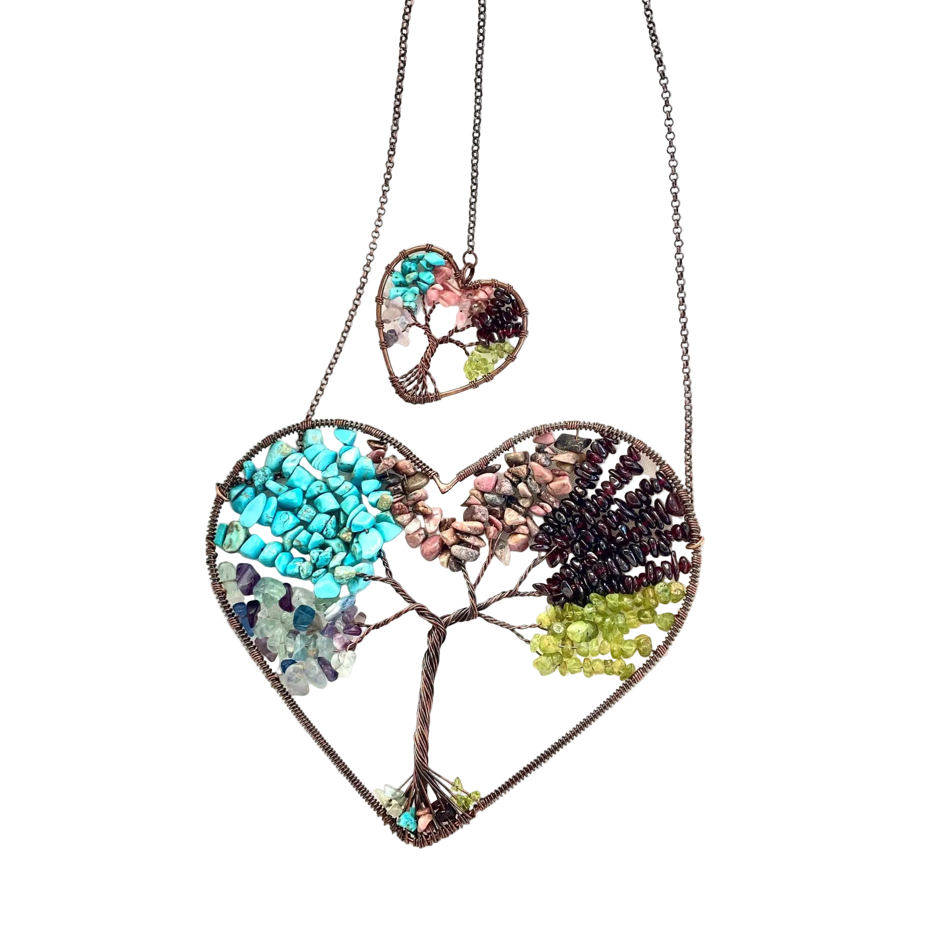Heart-shaped necklace with a tree design on a white fabric background